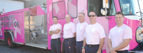 picture of firefighters standing in front of firetruck